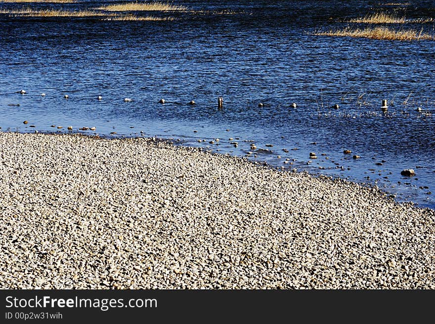 Winter lake shore in a garden