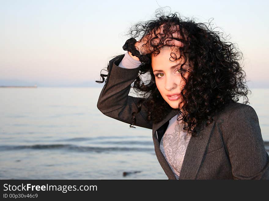 A beautiful woman at the beach holding her head