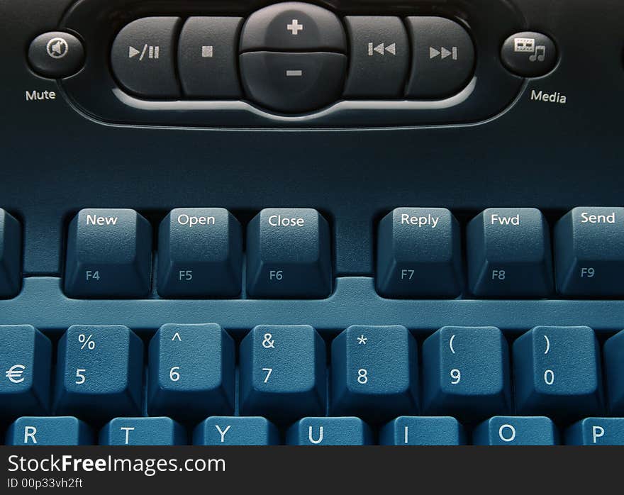 Close-up of media computer keyboard overlaid with blue. Close-up of media computer keyboard overlaid with blue