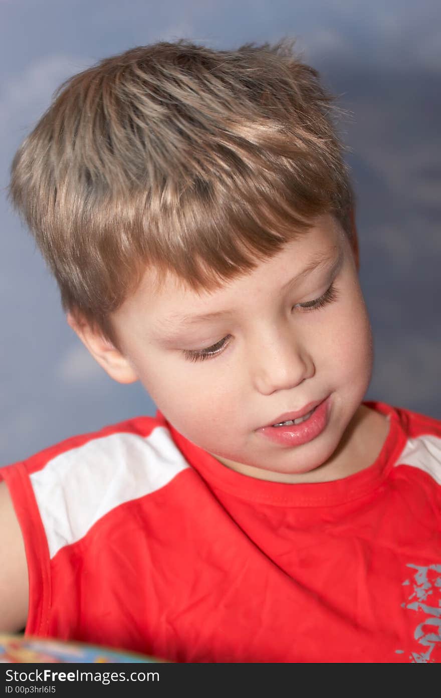 Young boy reading the book and thinking about it