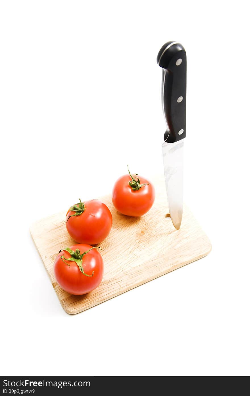 Three red tomato on kitchen board. Three red tomato on kitchen board