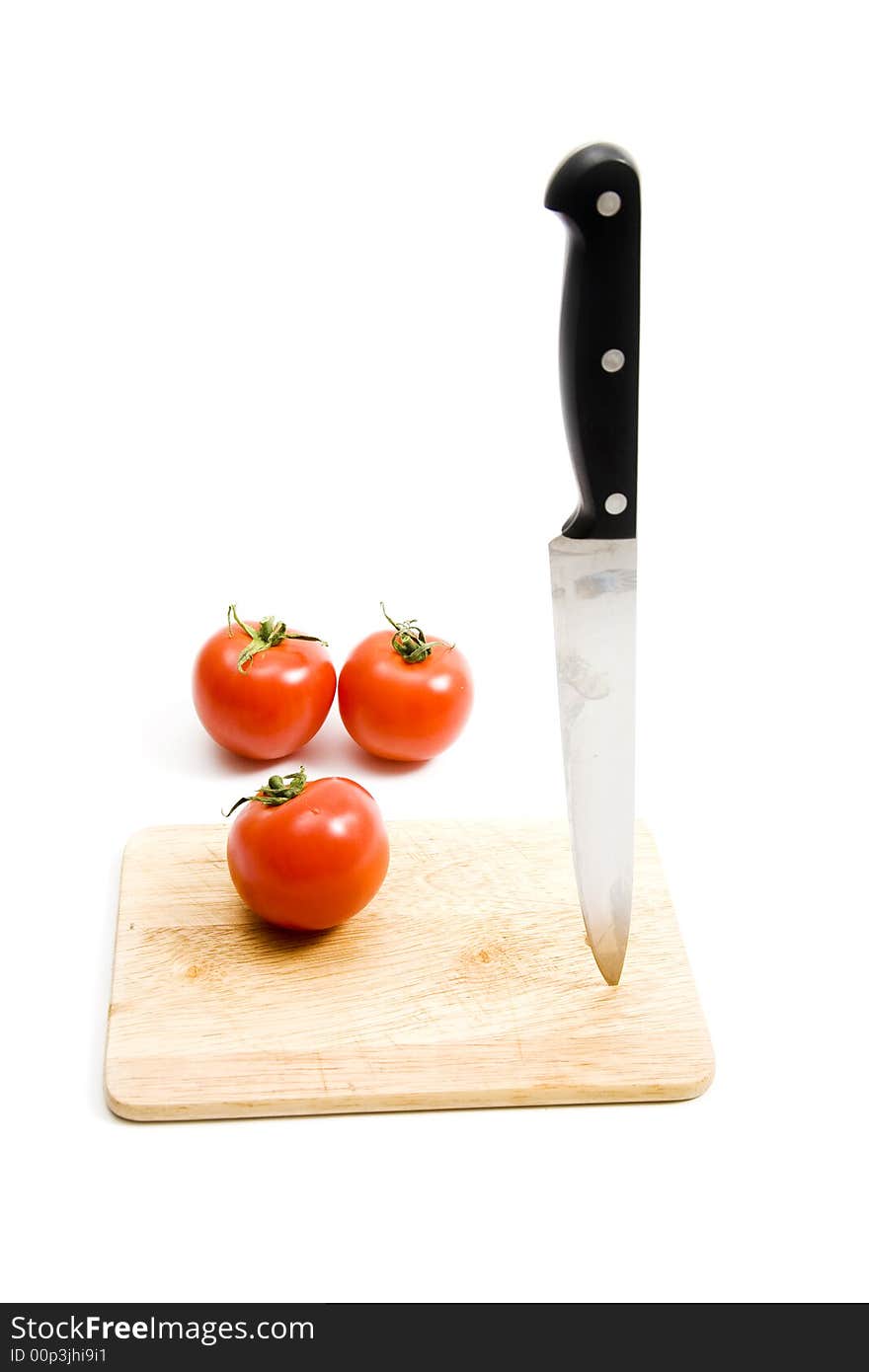 Three red tomato on kitchen board. Three red tomato on kitchen board