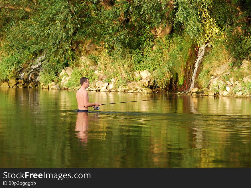 Fisherman angling on the river