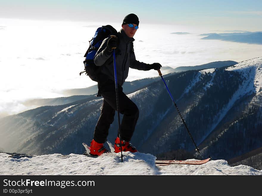 Young handsome skier on mountain