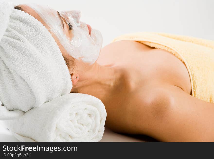 Woman with facial mask lying on neck support while sleeping. Woman with facial mask lying on neck support while sleeping.