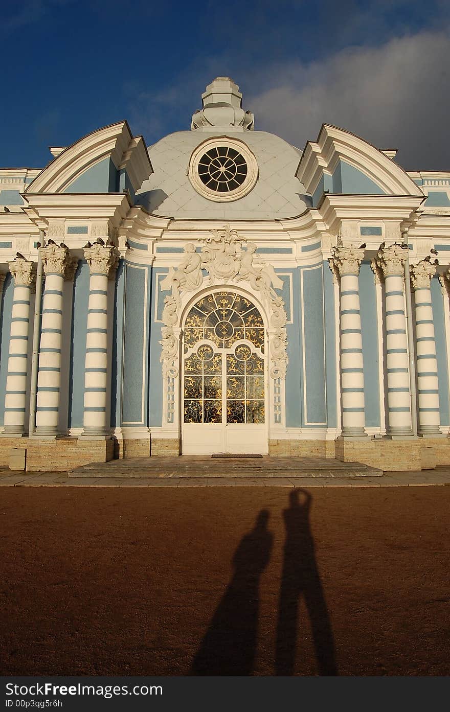 A couple standing in front of the building belonging to Tsarkie Sielo, Saint Petersburg. A couple standing in front of the building belonging to Tsarkie Sielo, Saint Petersburg