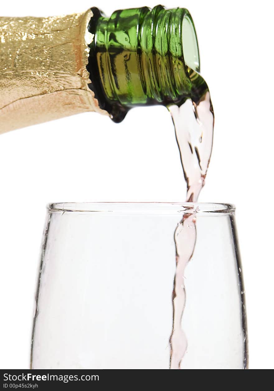 Glass of wine / champagne being poured with a white background. Glass of wine / champagne being poured with a white background