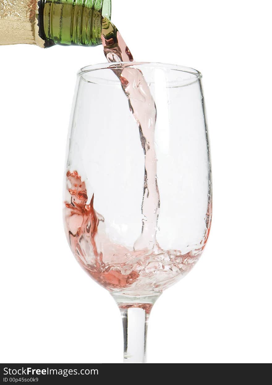 Glass of wine / champagne being poured with a white background. Glass of wine / champagne being poured with a white background