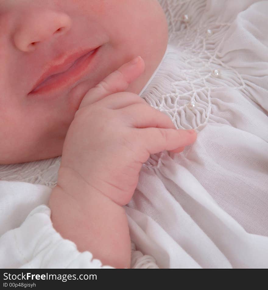 Features of baby's lower face with hand on chin. Features of baby's lower face with hand on chin