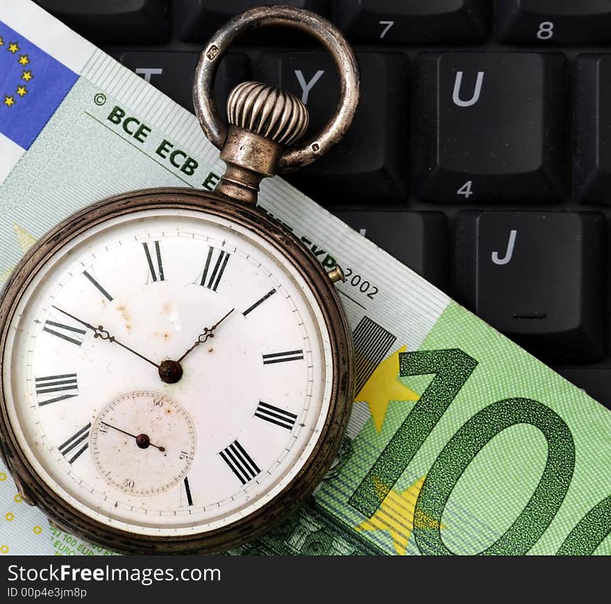 A view with a watch, banknote over a black keyboard. A view with a watch, banknote over a black keyboard