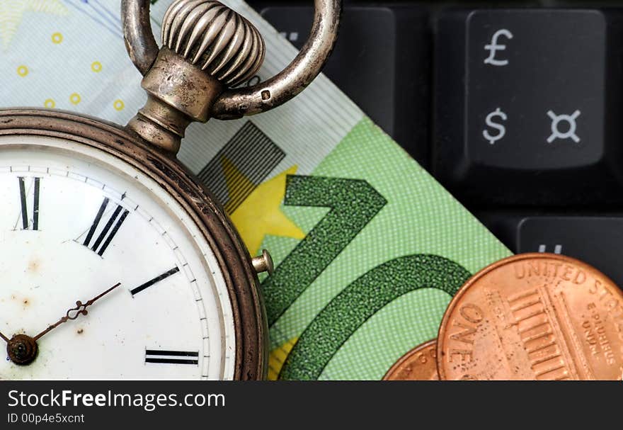 A view with a watch, banknote over a black keyboard. A view with a watch, banknote over a black keyboard