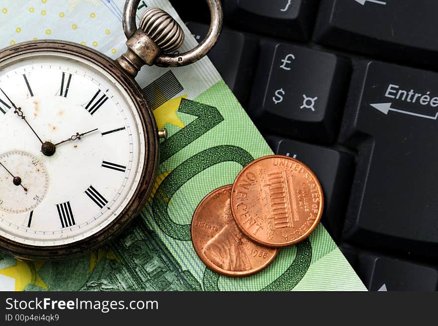 A view with a watch, banknote and coins over a black keyboard. A view with a watch, banknote and coins over a black keyboard