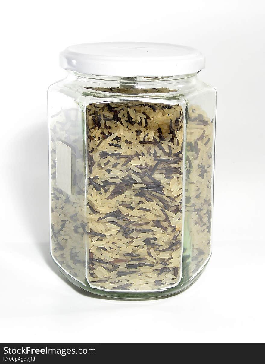 Mix of white and wild black rice in glass jar. Mix of white and wild black rice in glass jar