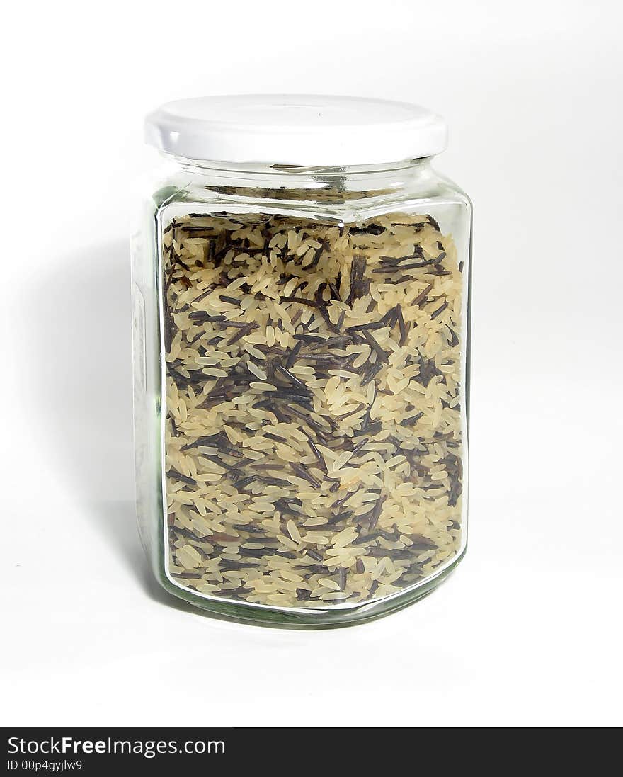 Mix of white and wild black rice in glass jar. Mix of white and wild black rice in glass jar