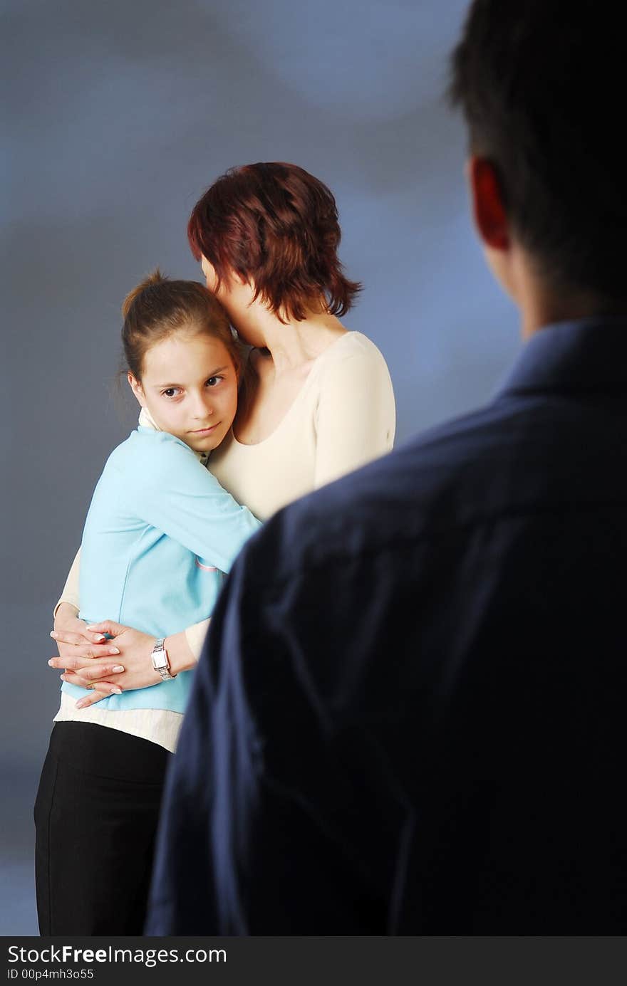 A mother and her daughter holding each other. A mother and her daughter holding each other