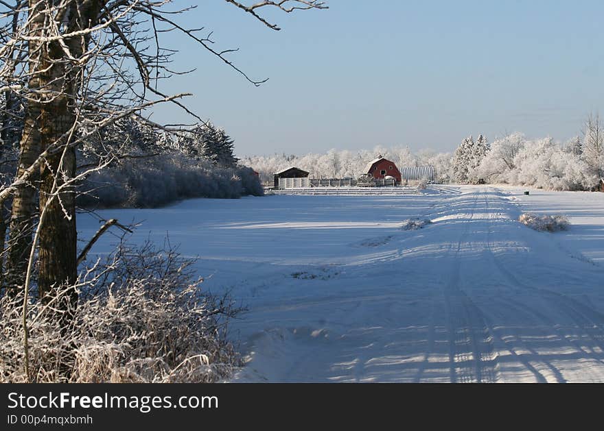 A red barn in a winter farmyard