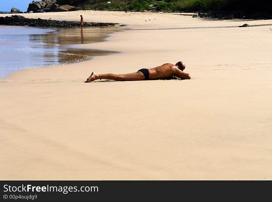 Sunburnt men at beach lying. Sunburnt men at beach lying