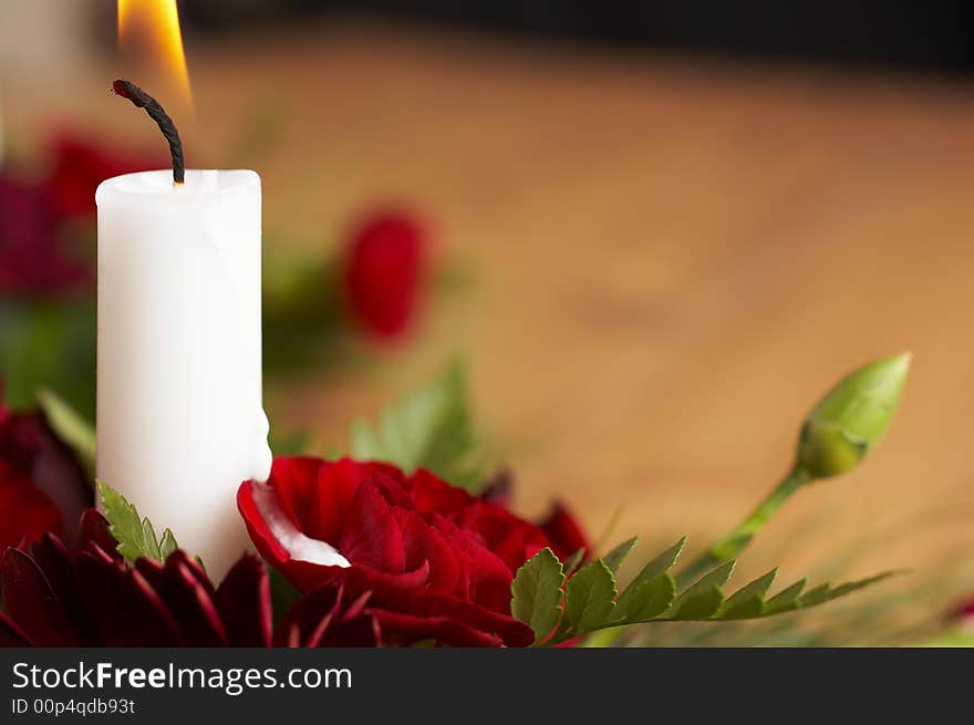 Candles with flower setup on the brown table