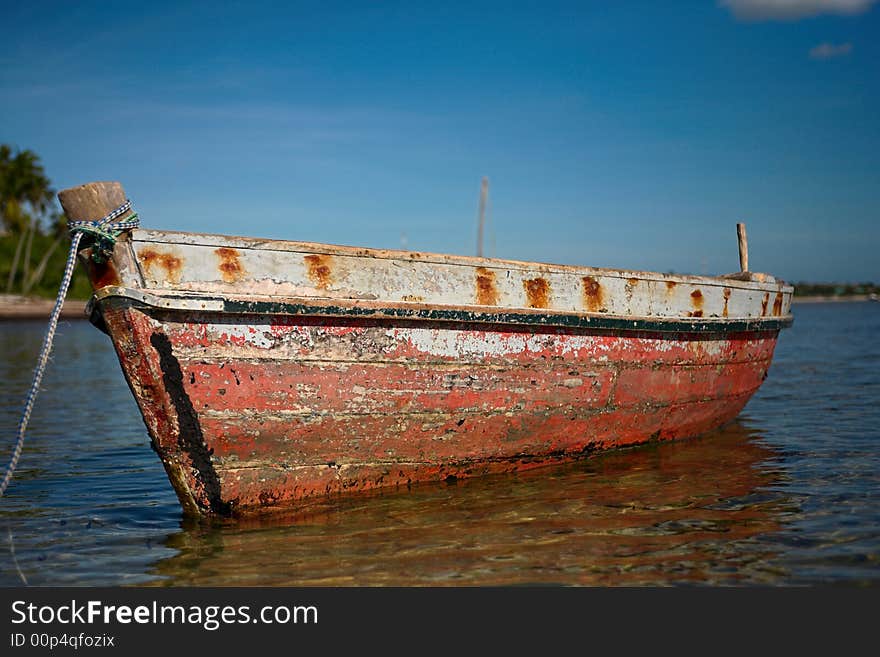 Red dhow or traditional wooden boat on the islands. See the rest in this series.