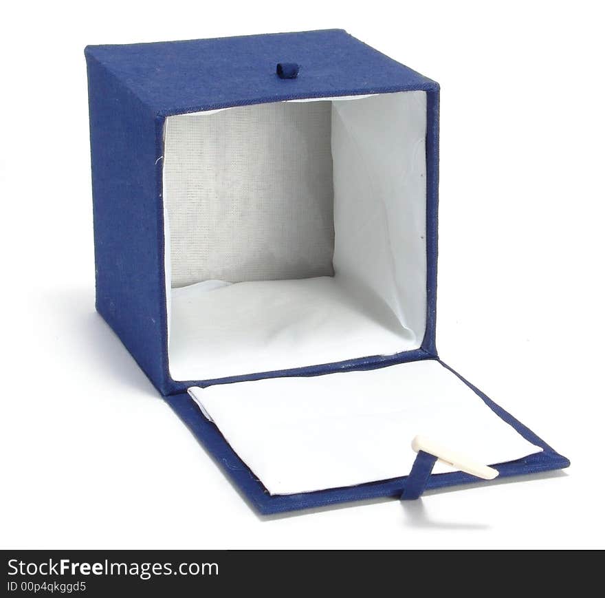 A box on a homogeneous background. Ornamented blue cloth. Inside the white cloth. A box on a homogeneous background. Ornamented blue cloth. Inside the white cloth.