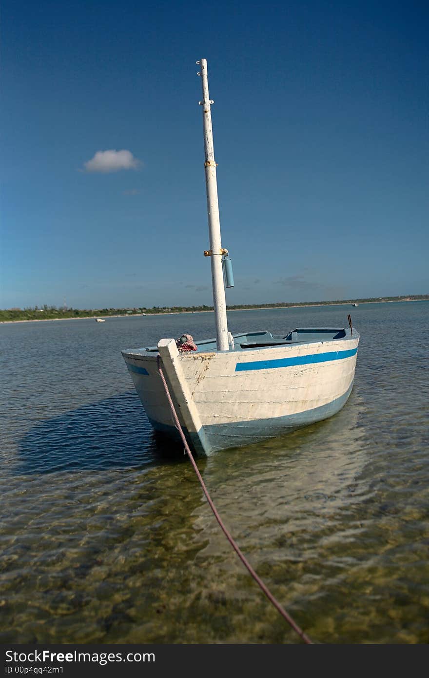 White dhow or traditional wooden boat on the islands. See the rest in this series.