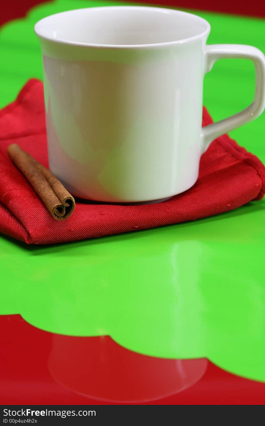 A coffee cup on a red and green table. A coffee cup on a red and green table