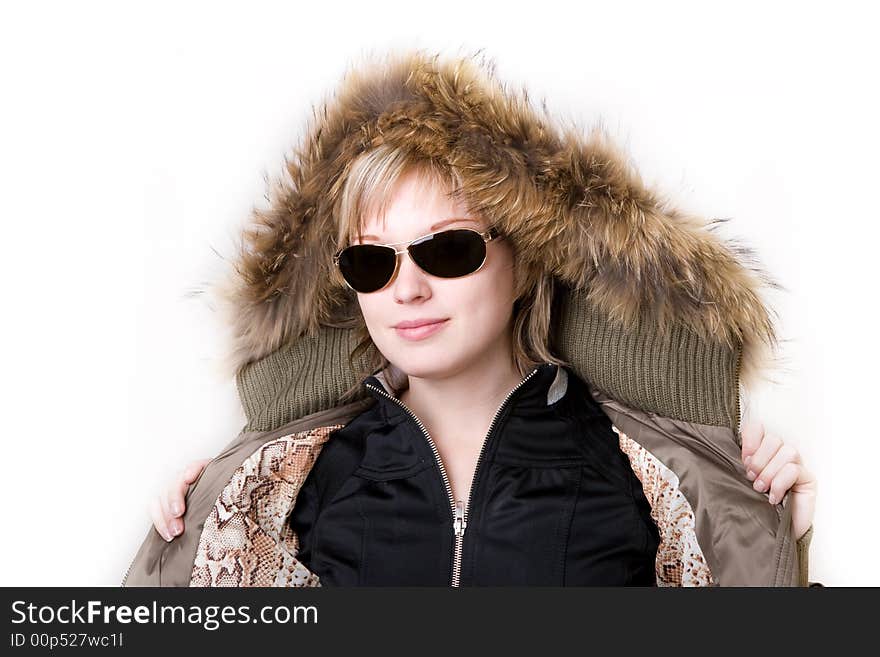 Playful girl with sunglasses in a jacket with a collar of fur