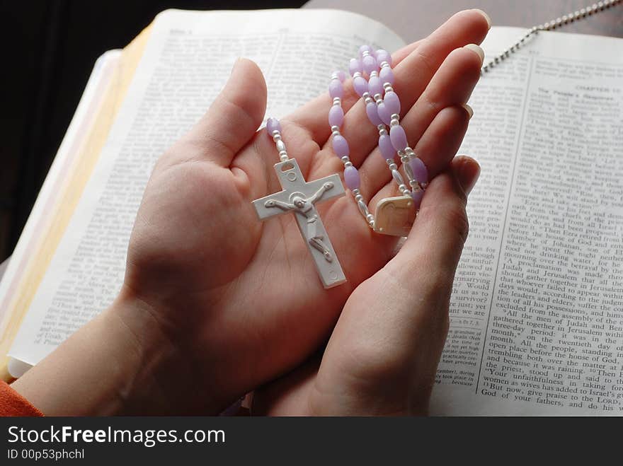 Holy bible open with a cross on a hand. Holy bible open with a cross on a hand