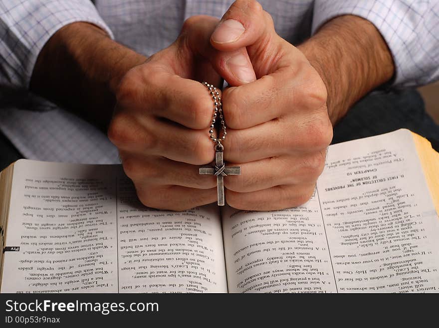 Holy bible open with a cross on a hand. Holy bible open with a cross on a hand