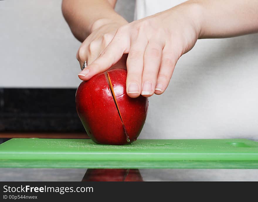 Apple on the counter symbolizes healthy living and nutritional value. Apple on the counter symbolizes healthy living and nutritional value