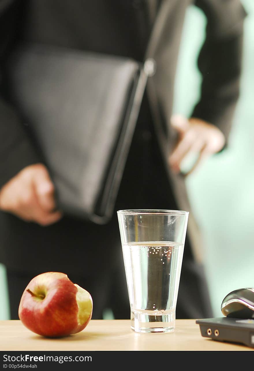 An apple and glass of water. An apple and glass of water