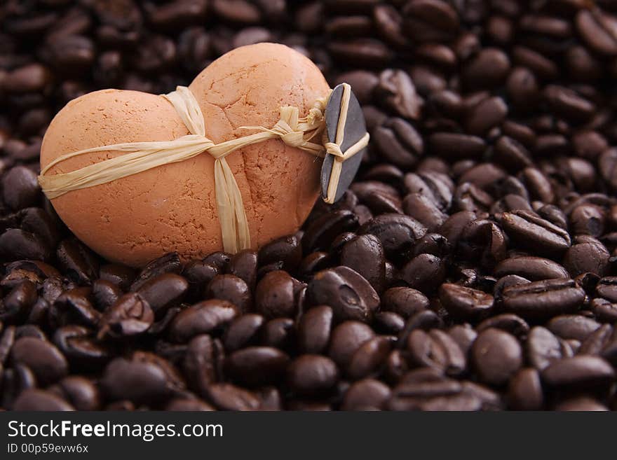 A clay heart in coffee beans. A clay heart in coffee beans