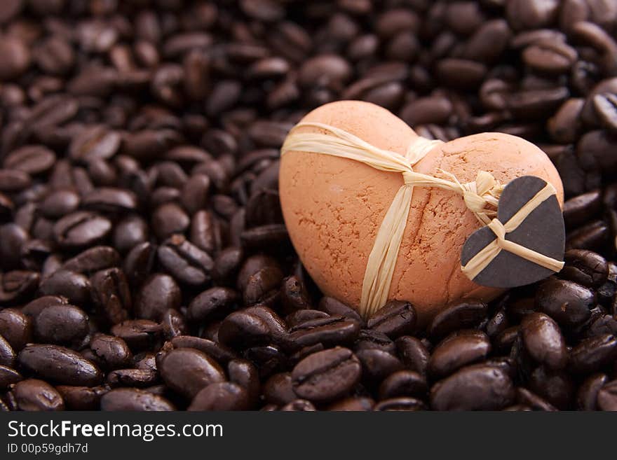 A clay heart in coffee beans. A clay heart in coffee beans