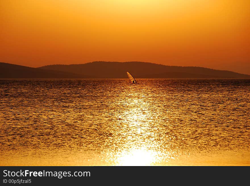 Windsurfing under a warm summer's sun. Windsurfing under a warm summer's sun