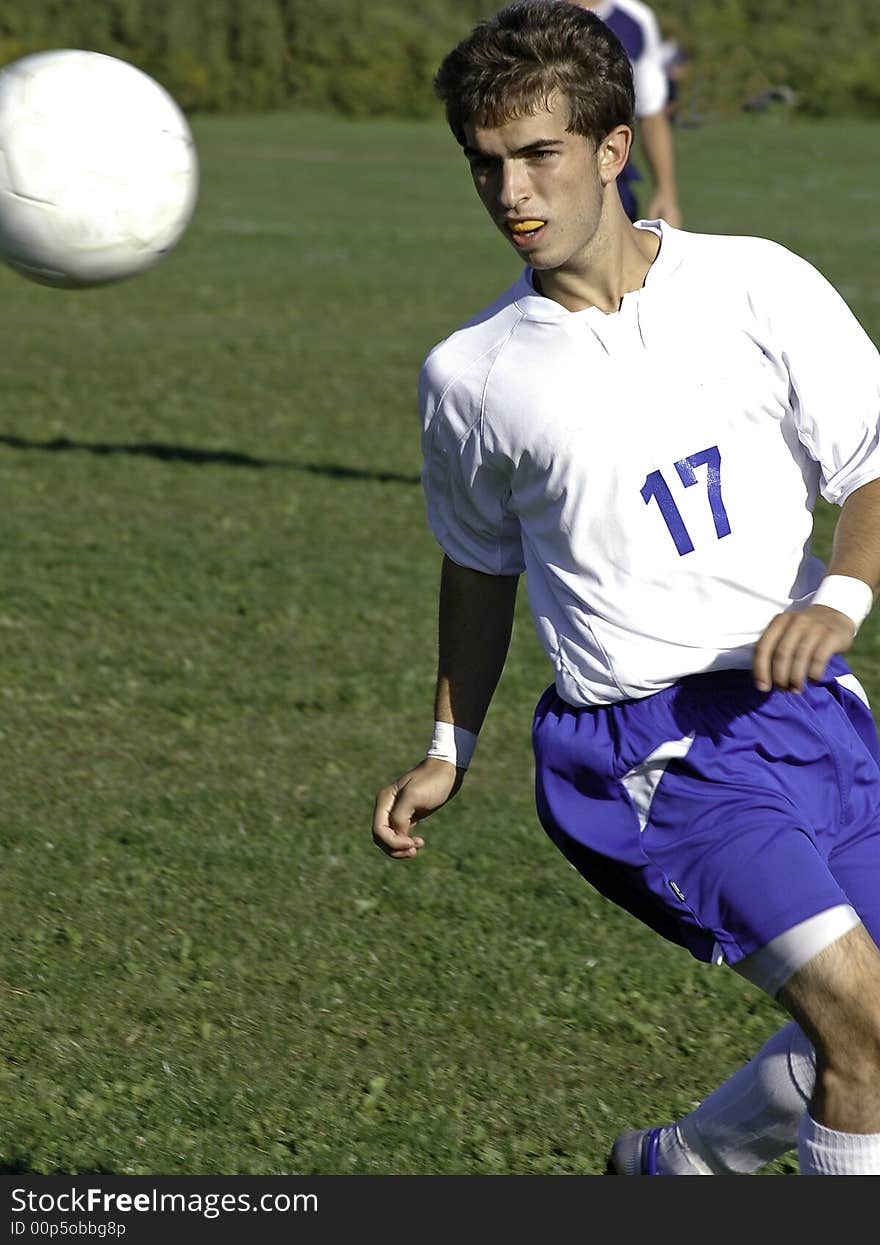 Soccer player lines up on ball for a kick. Soccer player lines up on ball for a kick