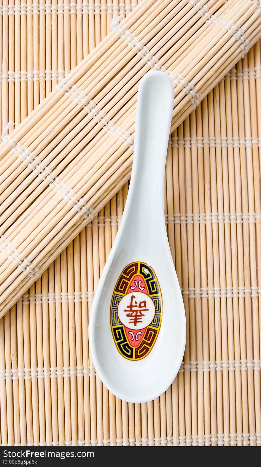 A  soup spoon on bamboo used for rolling sushi.