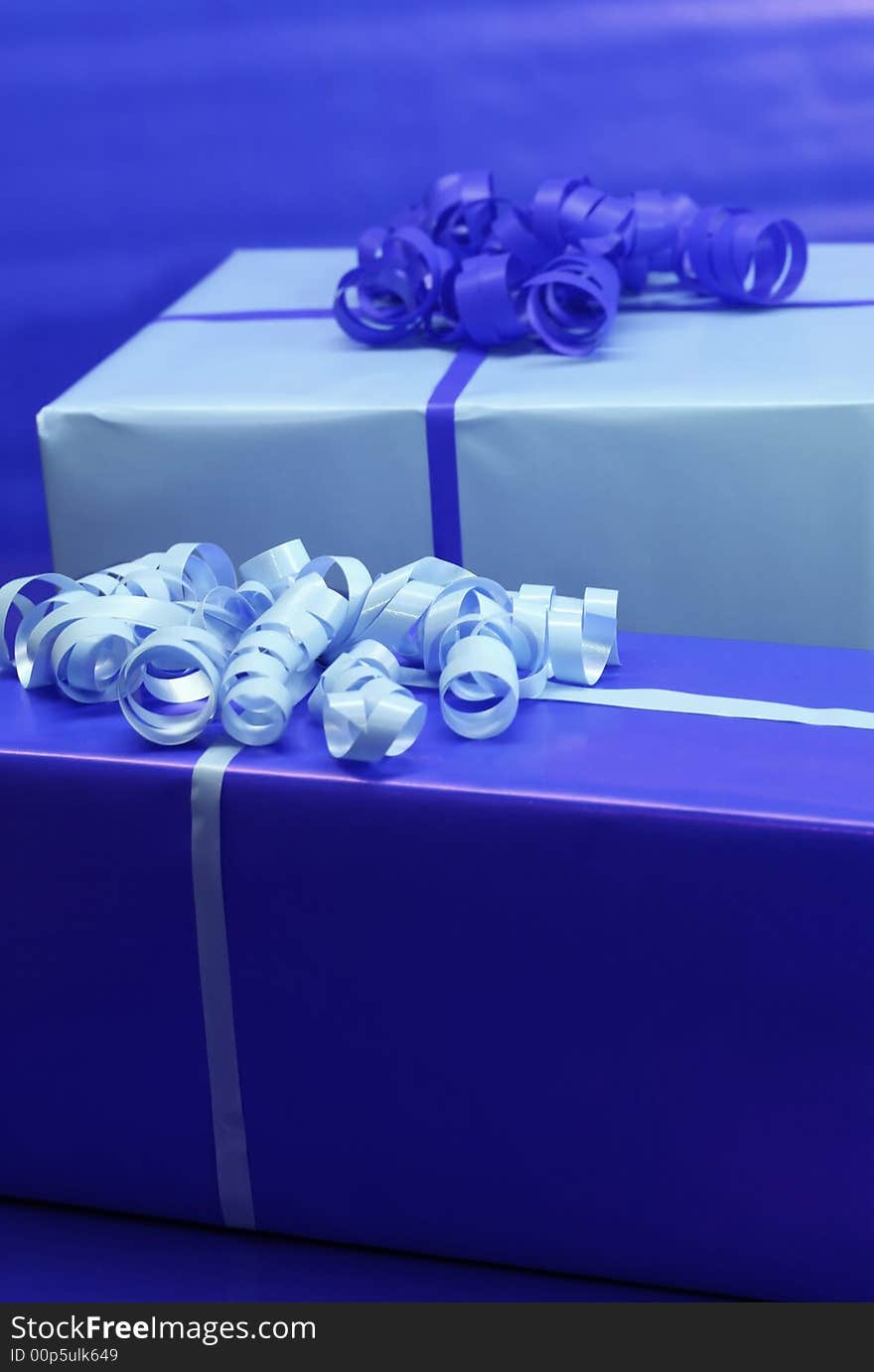 Presents wrapped in blue wrapping paper and ribbon. Presents wrapped in blue wrapping paper and ribbon