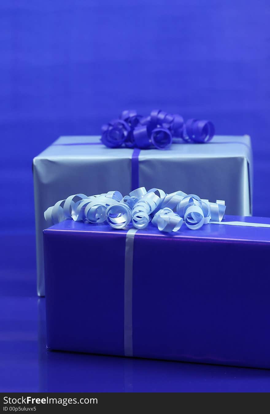 Presents wrapped in light and dark blue paper. Presents wrapped in light and dark blue paper