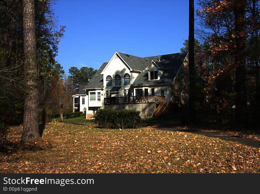 Two-story country house, blue sky. Autumn. Two-story country house, blue sky. Autumn