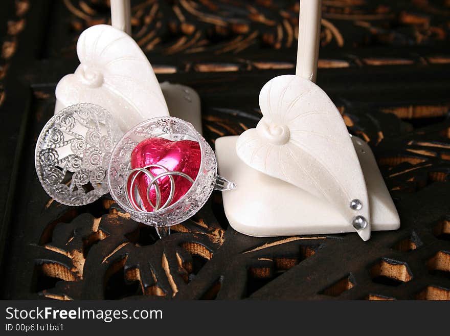 Decorated long stem glasses with a chocolate heart and rings. Decorated long stem glasses with a chocolate heart and rings