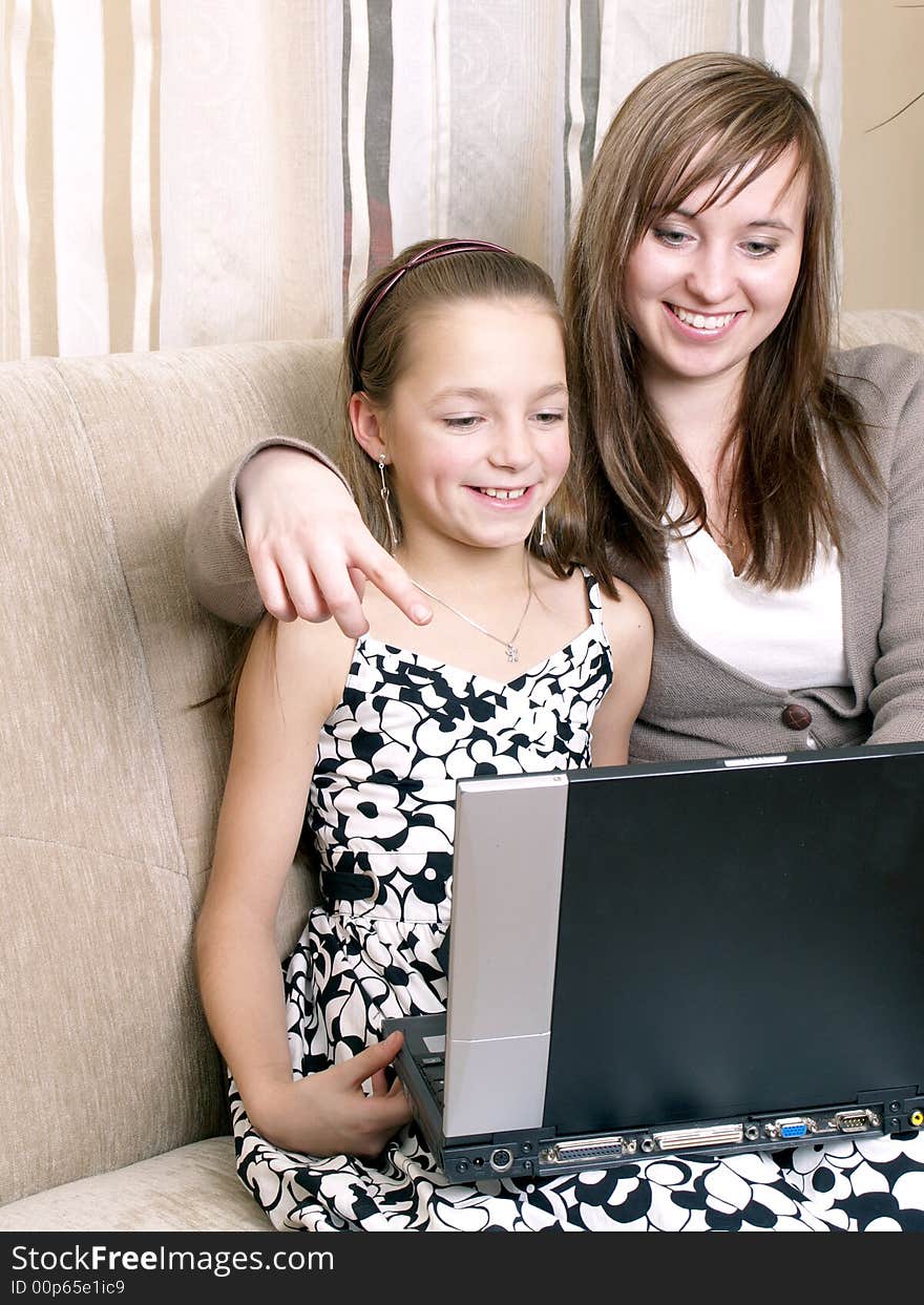 Mother and daughter using a laptop.