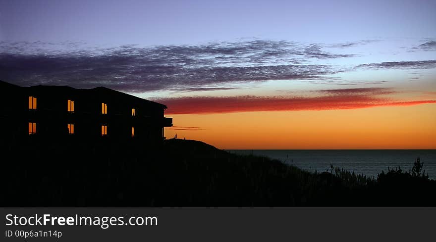 Hotel with lit windows at a sunset. Hotel with lit windows at a sunset