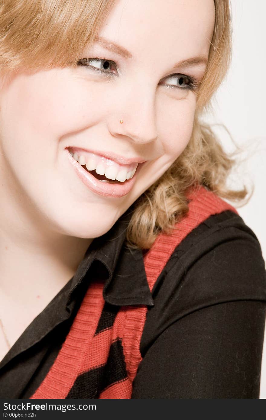 Studio portrait of a young blond curly woman laughing. Studio portrait of a young blond curly woman laughing