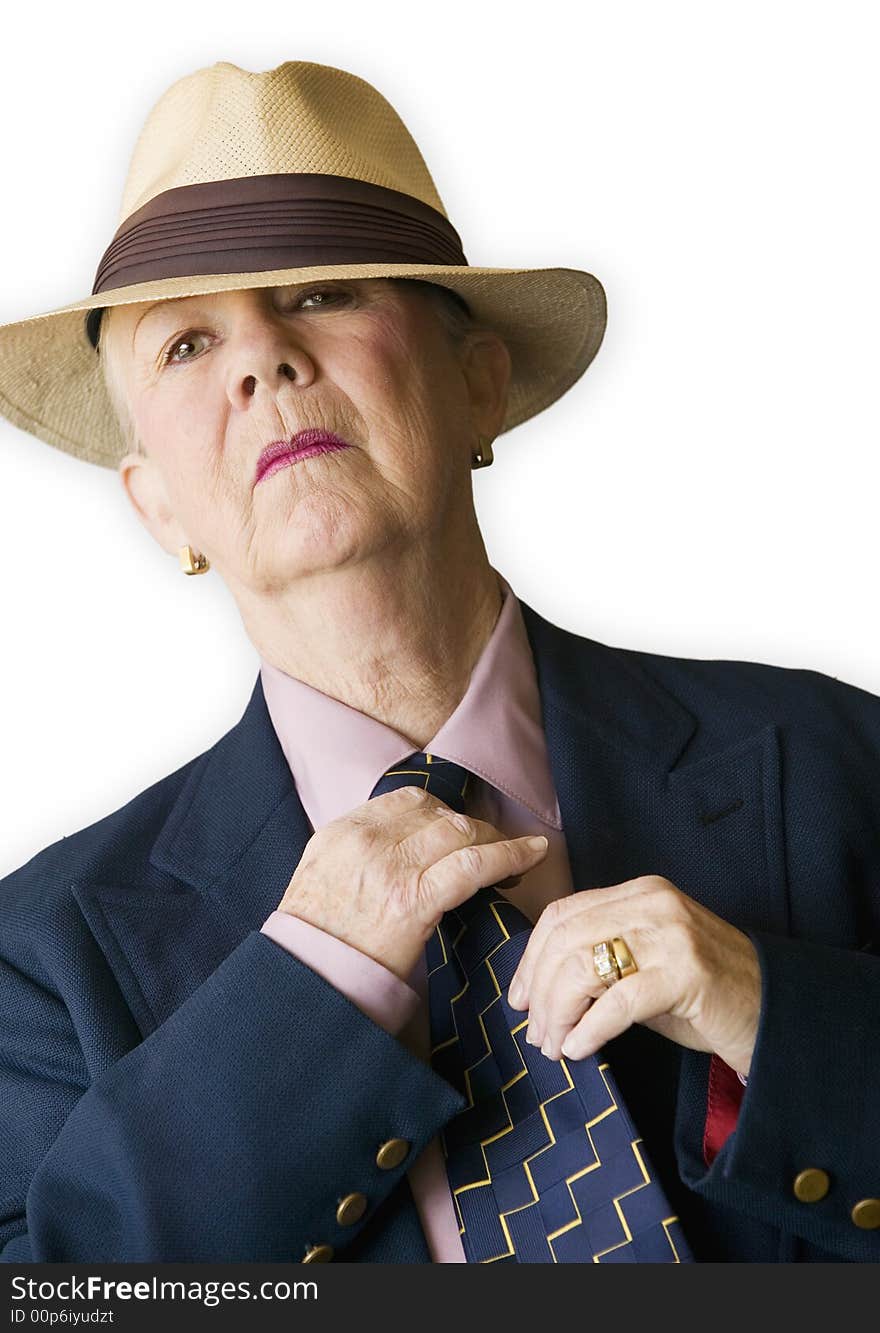 Woman wearing a man's hat and suit adjusting her tie. Woman wearing a man's hat and suit adjusting her tie.