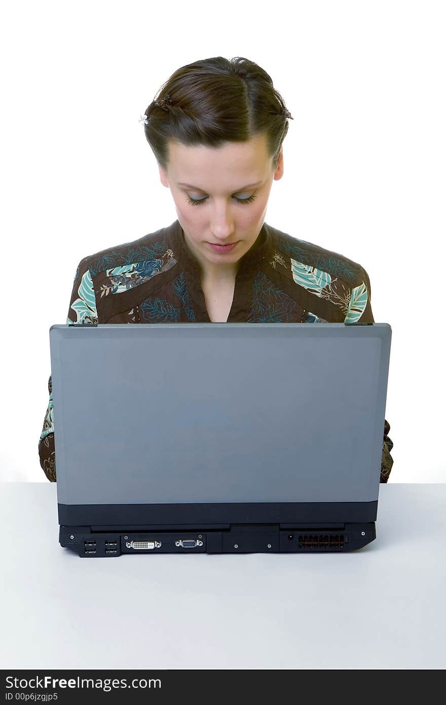 Portrait of an adorable business woman working at her desk with a laptop. Portrait of an adorable business woman working at her desk with a laptop