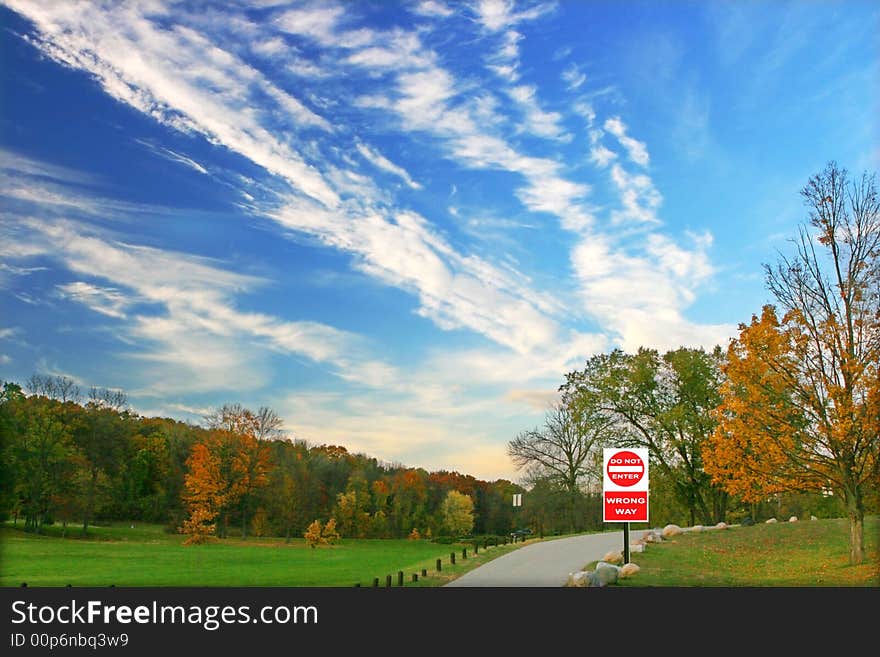 Colorful trees beautiful sky converges at a stop sign