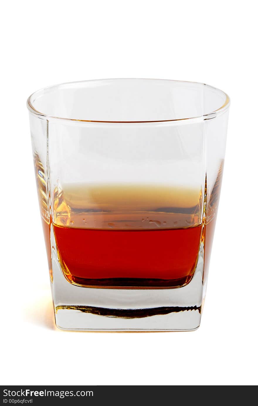 Whiskey in a tetrahedral glass. Object over white. Whiskey in a tetrahedral glass. Object over white.