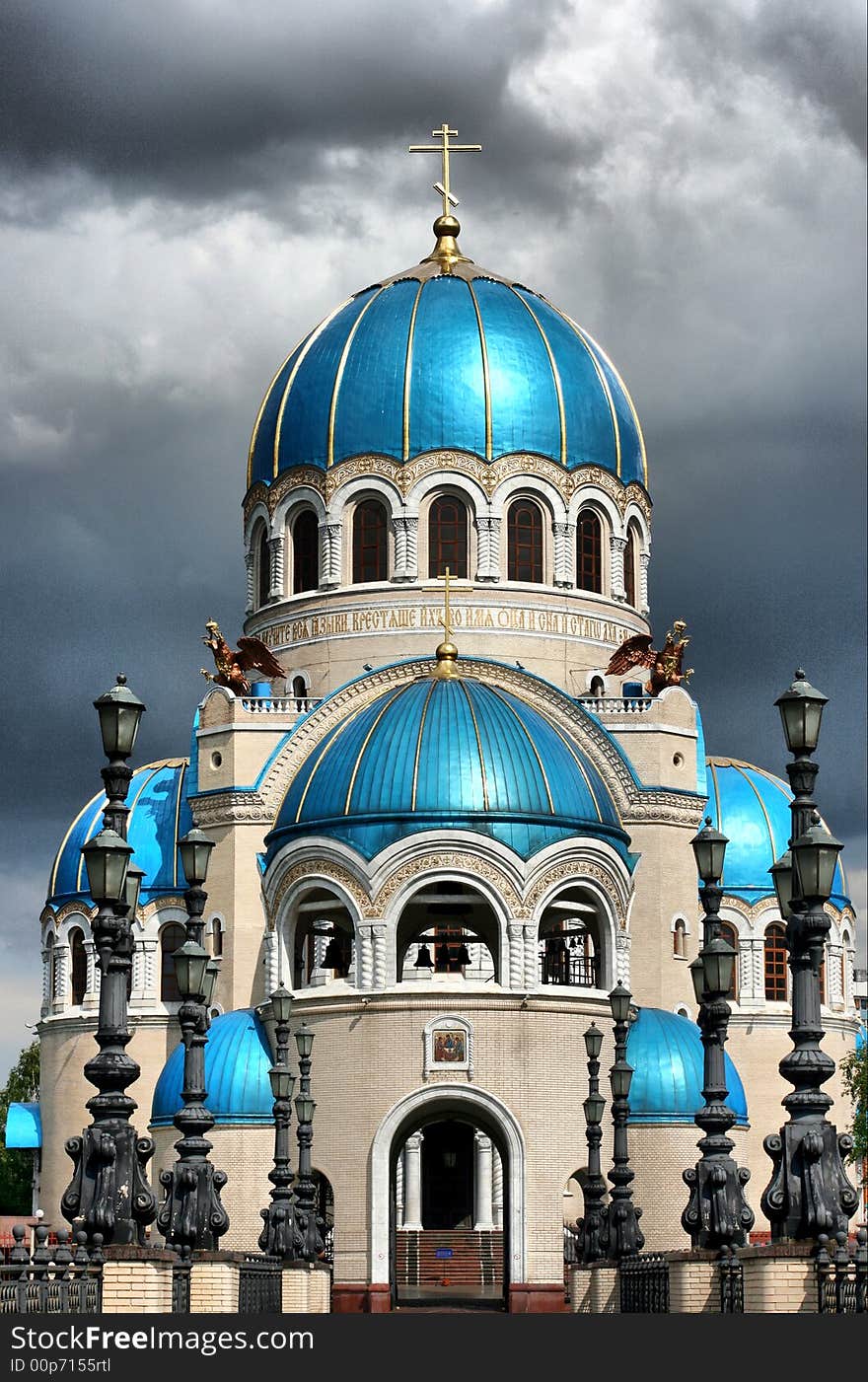 Temple with blue domes on a background of clouds