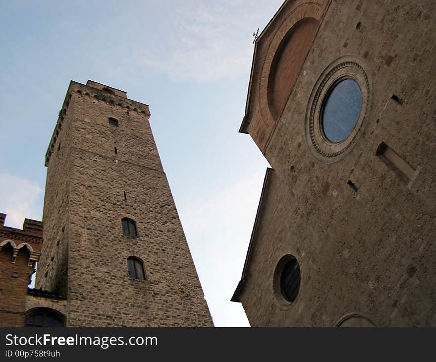 Medieval church and belltower in dusk light, looking up view. Medieval church and belltower in dusk light, looking up view