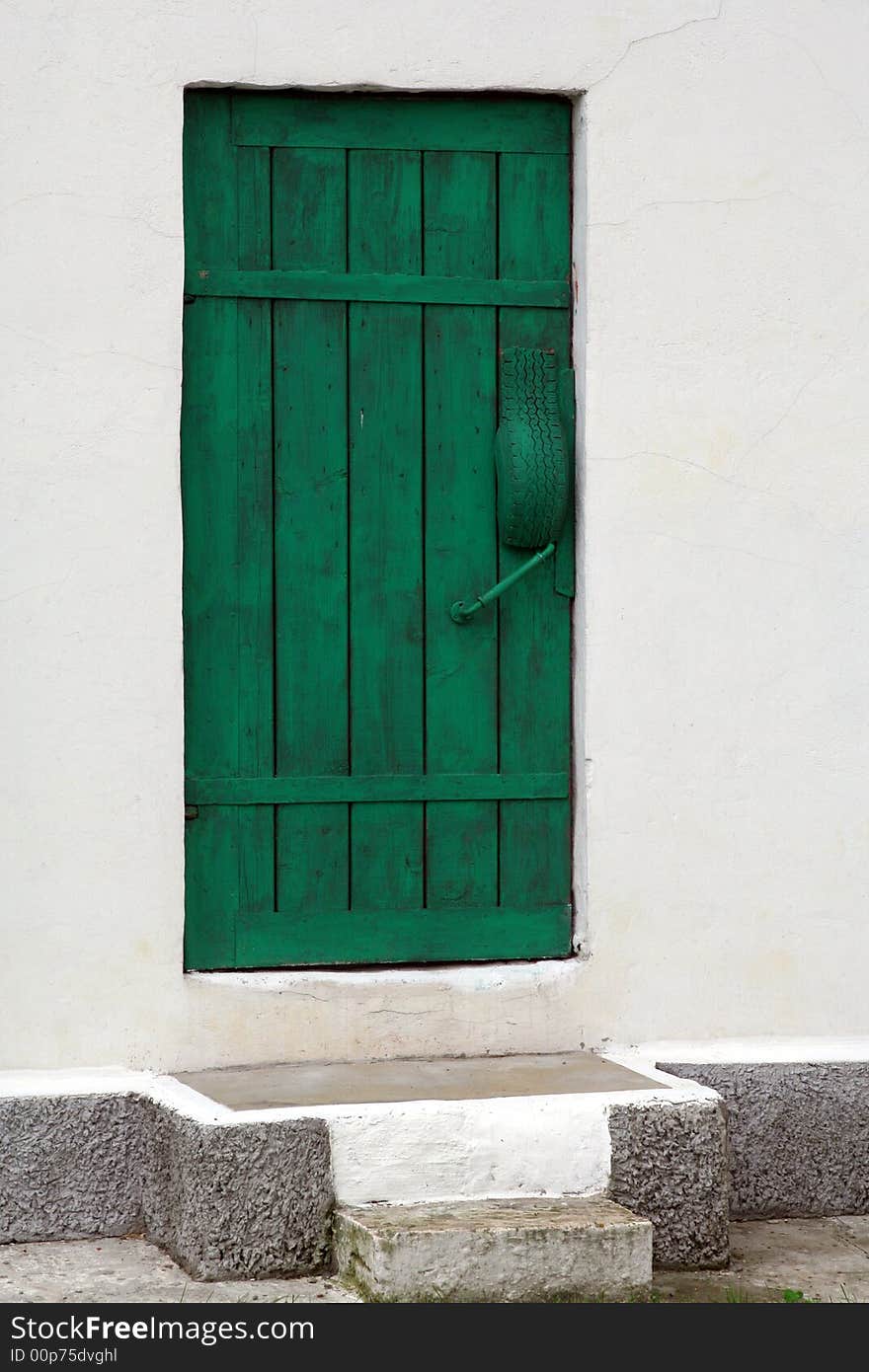 Green door in white wall